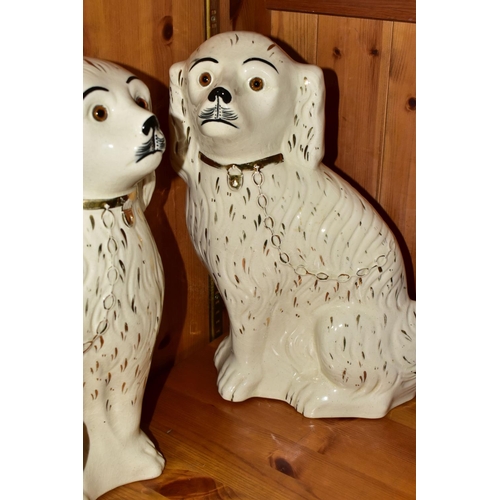 394 - A FISCHER AND MIEG FIGURE OF A SEATED SPANIEL AND A LARGE PAIR OF SADLER STAFFORDSHIRE SPANIELS, the... 