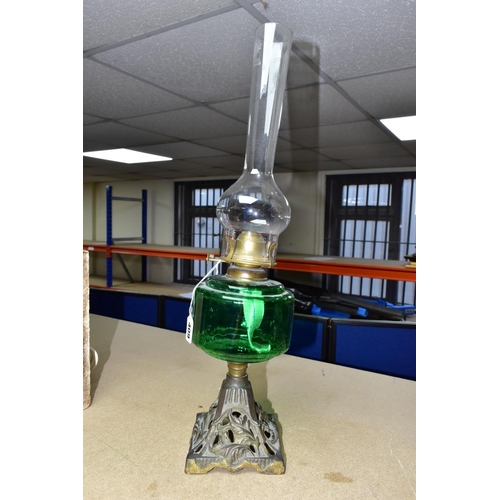 409 - A VICTORIAN OIL LAMP, with a green glass reservoir, cast foliate base and a Diamond Brand clear glas... 