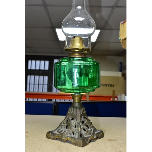 409 - A VICTORIAN OIL LAMP, with a green glass reservoir, cast foliate base and a Diamond Brand clear glas... 