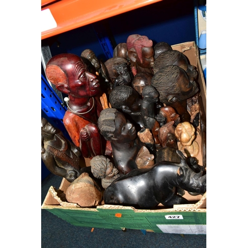 427 - A BOX OF WOODEN TOURIST TRIBAL ITEMS, to include mainly busts and figures of men and women, tallest ... 