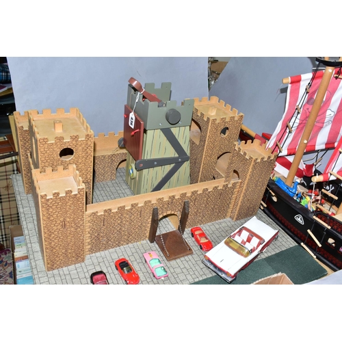 436 - AN EARLY LEARNING CENTRE CASTLE AND PIRATE SHIP, the castle on baseboard measuring 62cm x 61cm, havi... 