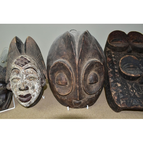 464 - FIVE TWENTIETH CENTURY WOODEN MASKS, four of African styles, the fifth in an Asian style (possibly B... 