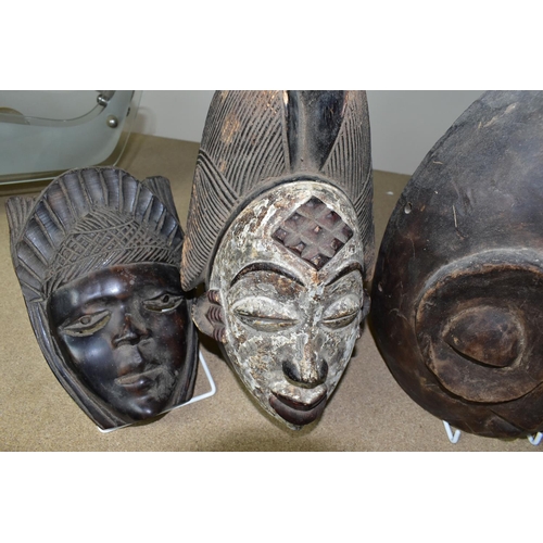 464 - FIVE TWENTIETH CENTURY WOODEN MASKS, four of African styles, the fifth in an Asian style (possibly B... 