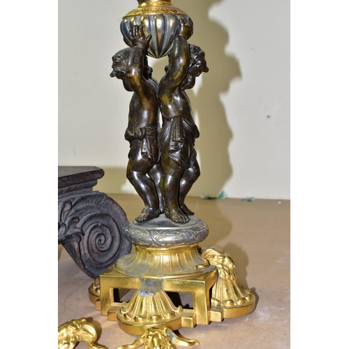 504 - A DECORATIVE ELECTRIC TABLE LAMP IN THE FORM OF AN OIL LAMP, comprising a cast brass base, reservoir... 