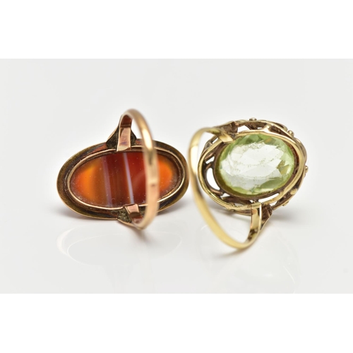 1 - TWO GEM SET RINGS, the first of an oval form, set with an oval cut light green synthetic spinel, mil... 