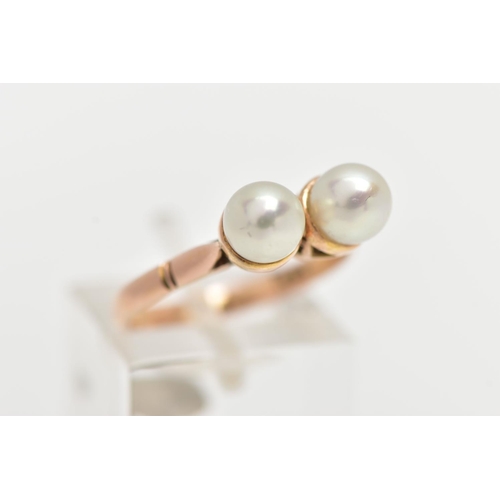 17 - A YELLOW METAL CULTURED PEARL RING, designed with two white cultured pearls, measuring approximately... 