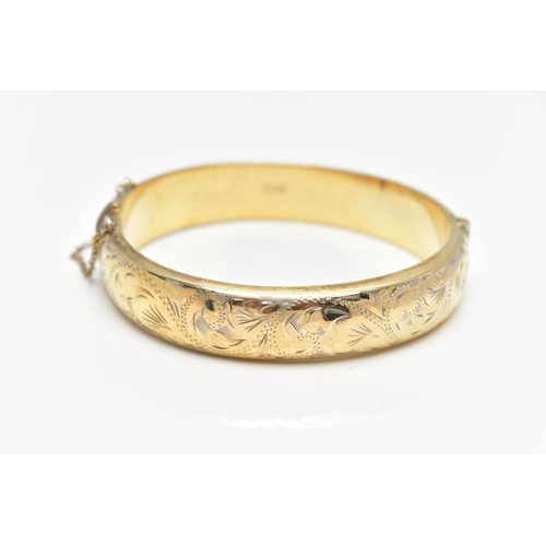 40 - A GOLD PLATED HINGED BANGLE, a hollow gold plated bangle with engraved foliage detail, approximate w... 