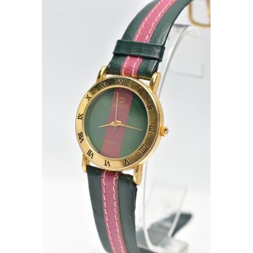 52 - A 'GUCCI' QUARTZ WRISTWATCH, featuring a round green and burgundy stripped dial signed 'Gucci quartz... 