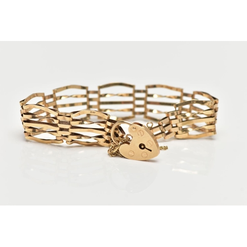 67 - A 9CT YELLOW GOLD GATE BRACELET, four bar bracelet, fitted with a heart padlock clasp, with addition... 