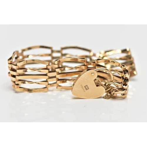 67 - A 9CT YELLOW GOLD GATE BRACELET, four bar bracelet, fitted with a heart padlock clasp, with addition... 