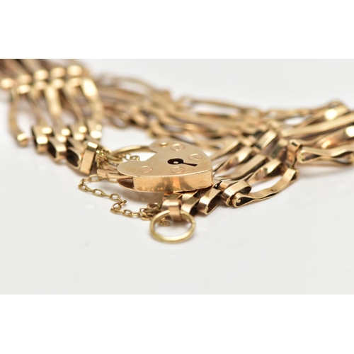 67 - A 9CT YELLOW GOLD GATE BRACELET, four bar bracelet, fitted with a heart padlock clasp, with addition... 