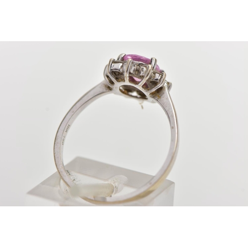 74 - AN 18CT WHITE GOLD PINK SAPPHIRE AND DIAMOND CLUSTER RING, centering on a four claw set, oval cut pi... 