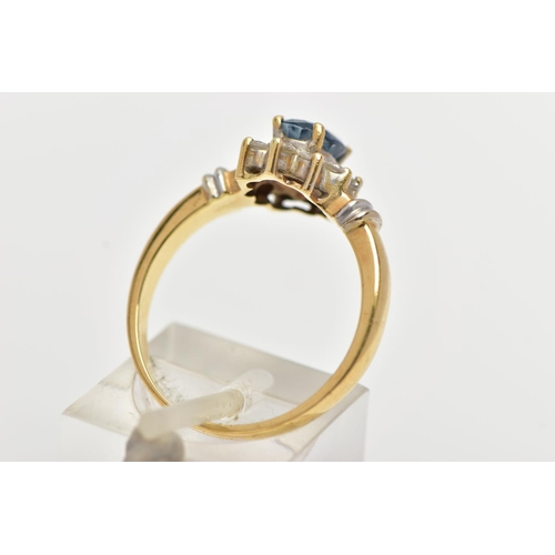 76 - AN 18CT GOLD SAPPIRE AND DIAMOND CLUSTER RING, centering on a raised oval cut blue sapphire, within ... 