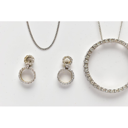 82 - A 9CT WHITE GOLD DIAMOND PENDANT NECKLACE AND MATCHING EARRINGS, the pendant of an openwork circular... 