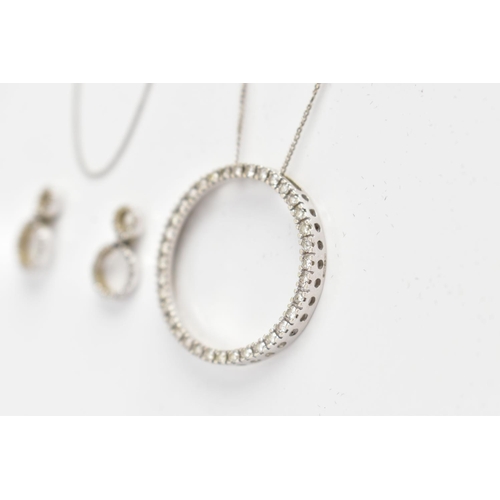 82 - A 9CT WHITE GOLD DIAMOND PENDANT NECKLACE AND MATCHING EARRINGS, the pendant of an openwork circular... 