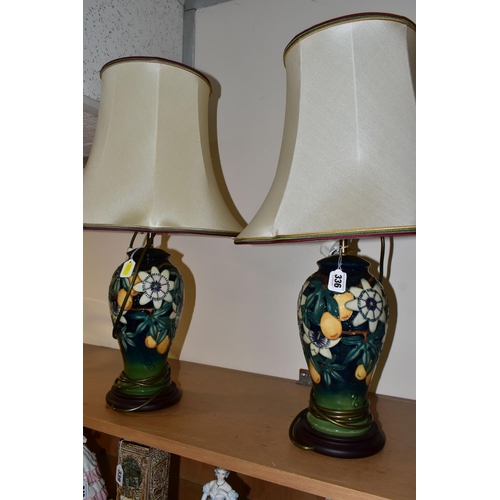 336 - A PAIR OF MOORCROFT POTTERY 'PASSION FLOWER' TABLE LAMPS, of baluster form, with tube lined passion ... 