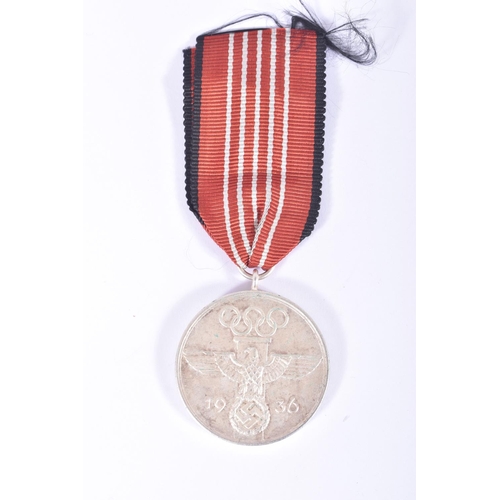 237 - A NSDAP BLOOD ORDER MEDAL AND A 1936 OLYMPIC MEDAL, the blood order is officially known as the Decor... 