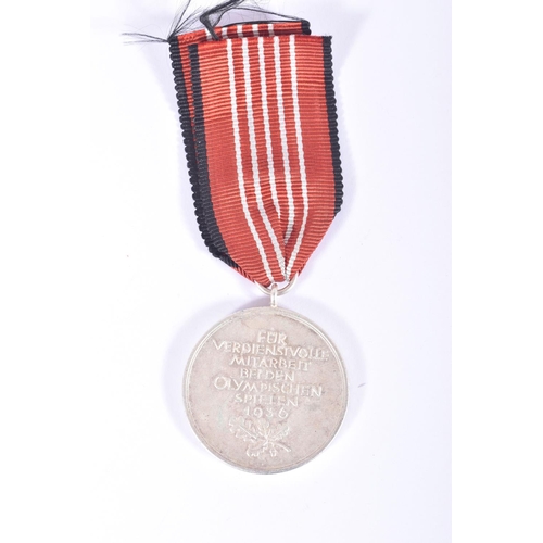 237 - A NSDAP BLOOD ORDER MEDAL AND A 1936 OLYMPIC MEDAL, the blood order is officially known as the Decor... 