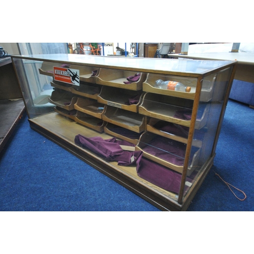 1319 - AN EARLY 20TH OAK HABERDASHERY SHOP DISPLAY COUNTER, with 16 drawers which graduated internally, wid... 