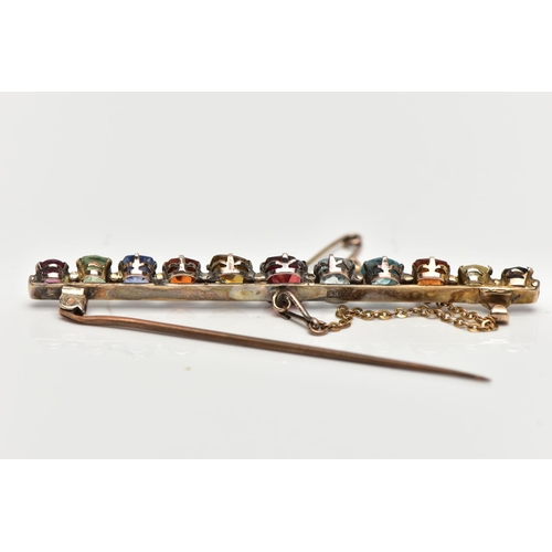 107 - A YELLOW METAL MULTI GEMSTONE BAR BROOCH, designed with a row of vary cut gemstones, each claw set, ... 