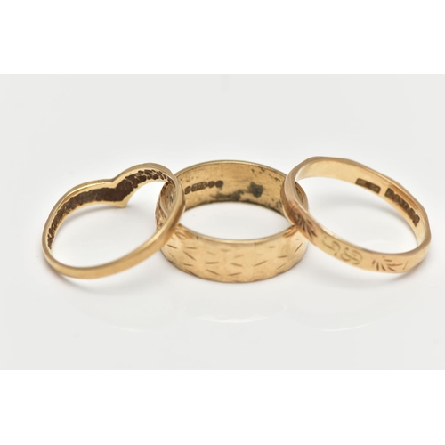 28 - THREE 9CT YELLOW GOLD RINGS, to include a wide band with engraved detail, a wish bone ring and a fac... 