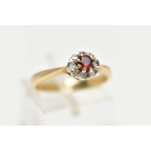 30 - A 9CT GOLD GARNET AND PASTE CLUSTER RING, the principal garnet, within a colourless paste surround, ... 