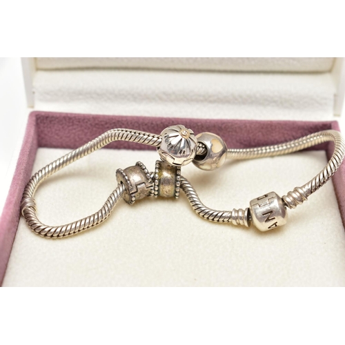 41 - A PANDORA CHARM BRACELET, suspending four charms including a spherical charm inlaid with mother of p... 