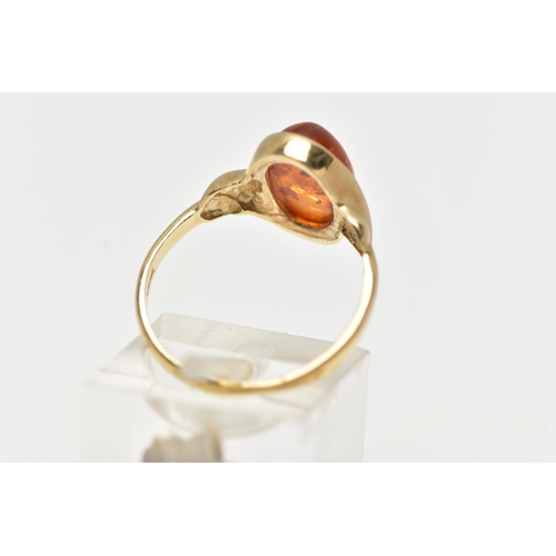 47 - A 9CT YELLOW GOLD AMBER CABOCHON RNIG, collet set with an oval cut amber cabochon, twist detail to t... 