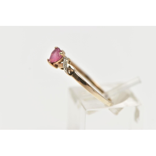 49 - A 9CT YELLOW GOLD , RUBY AND DIAMOND RING, designed with a heart cut ruby, four claw set between cro... 