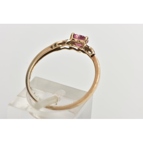 49 - A 9CT YELLOW GOLD , RUBY AND DIAMOND RING, designed with a heart cut ruby, four claw set between cro... 