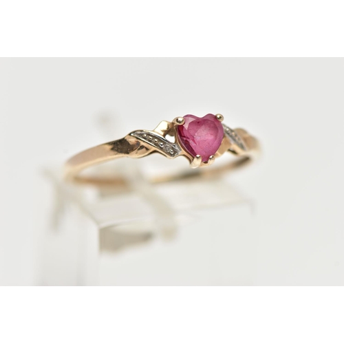 49 - A 9CT YELLOW GOLD , RUBY AND DIAMOND RING, designed with a heart cut ruby, four claw set between cro... 