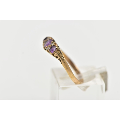 50 - A 9CT YELLOW GOLD GEM SET RING, set with three slightly graduated circular cut amethyst, interspaced... 