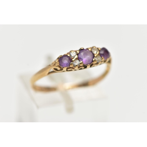 50 - A 9CT YELLOW GOLD GEM SET RING, set with three slightly graduated circular cut amethyst, interspaced... 