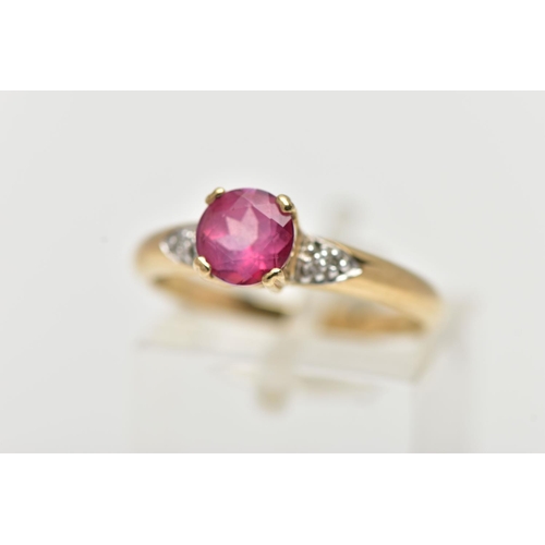 51 - A 9CT YELLOW GOLD, RUBY AND DIAMOND RING, centering on a four claw set, circular cut ruby, flanked w... 