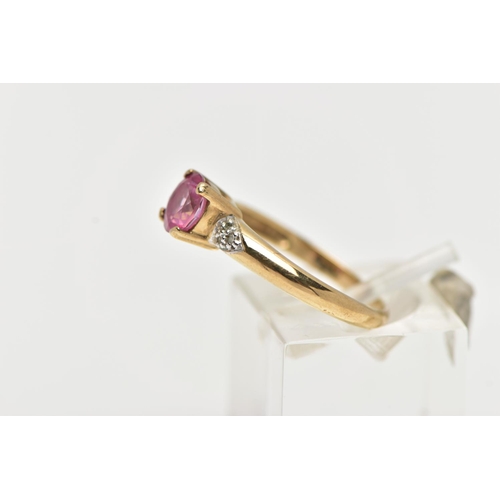 51 - A 9CT YELLOW GOLD, RUBY AND DIAMOND RING, centering on a four claw set, circular cut ruby, flanked w... 