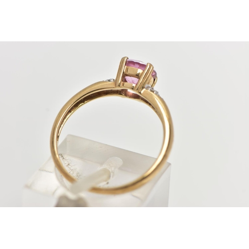 51 - A 9CT YELLOW GOLD, RUBY AND DIAMOND RING, centering on a four claw set, circular cut ruby, flanked w... 