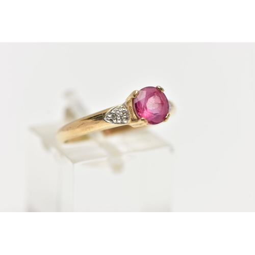 51 - A 9CT YELLOW GOLD, RUBY AND DIAMOND RING, centering on a four claw set, circular cut ruby, flanked w... 