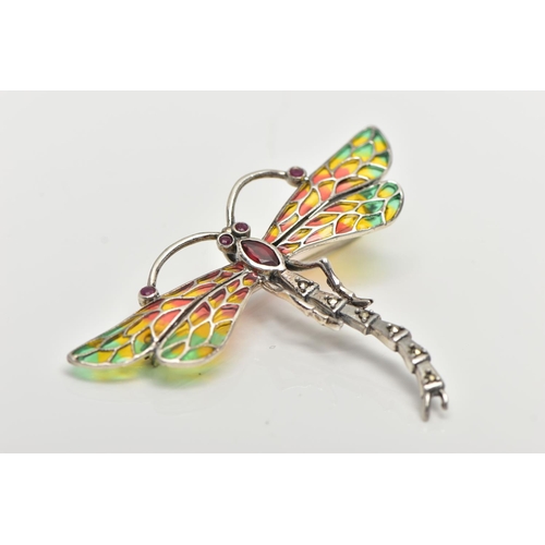 54 - A WHITE METAL PLIQUE A JOUR BROOCH/PENDANT, in the form of a dragonfly, set with ruby eyes and anten... 