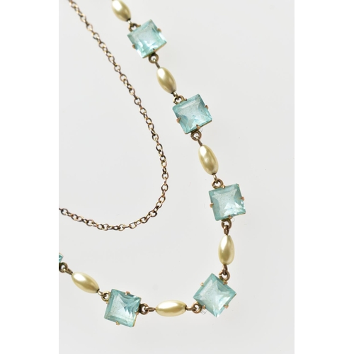 63 - A MID 20TH CENTURY YELLOW METAL NECKLACE  set with seven pale blue square cut pastes, each claw set ... 