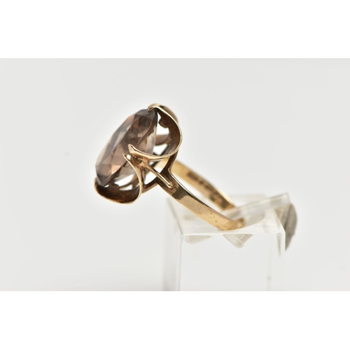 64 - A 9CT GOLD SMOKY QUARTZ RING, double four claw set, oval cut smoky quartz, measuring approximately l... 