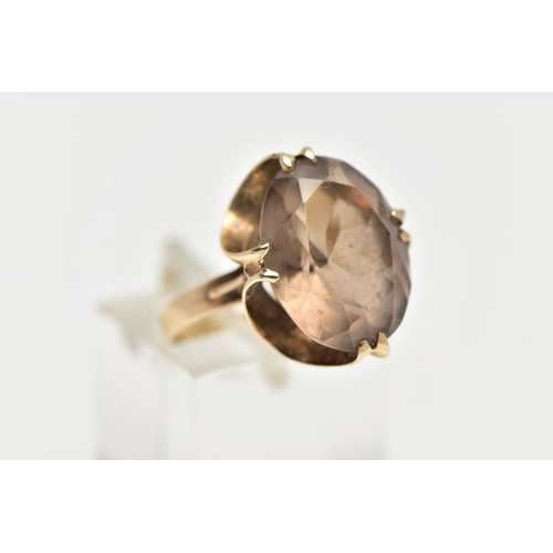 64 - A 9CT GOLD SMOKY QUARTZ RING, double four claw set, oval cut smoky quartz, measuring approximately l... 