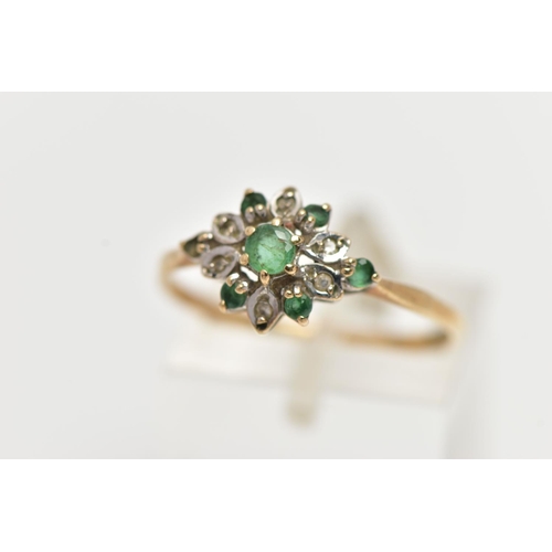 73 - A 9CT YELLOW GOLD, EMERALD AND DIAMOND CLUSTER RING, the cluster of a flower shape, set with a centr... 