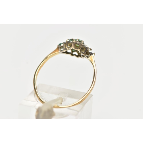 73 - A 9CT YELLOW GOLD, EMERALD AND DIAMOND CLUSTER RING, the cluster of a flower shape, set with a centr... 