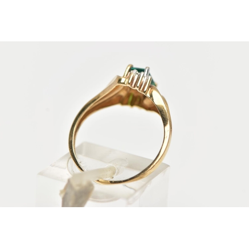 74 - A YELLOW METAL GEM SET RING, designed with a four claw set, rectangular cut emerald, between single ... 