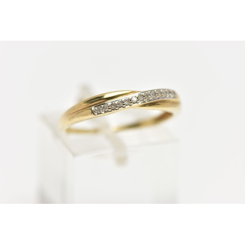 75 - A 9CT YELLOW GOLD DIAMOND HALF ETERNITY RING, cross over style set with a row of single cut diamonds... 