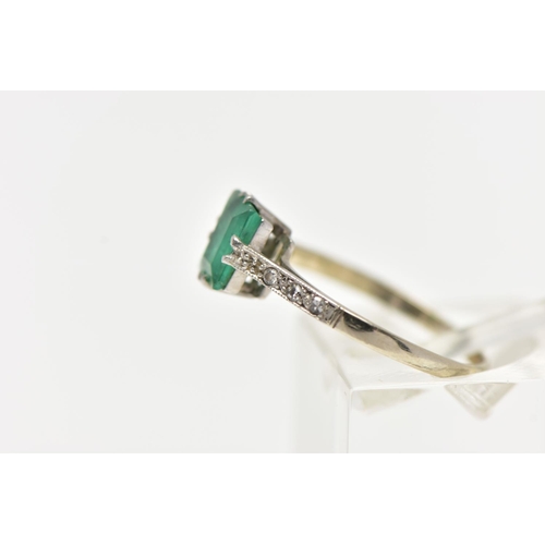 83 - A EMERALD RING, single emerald cut stones, split prong set in white metal flanked with six single cu... 