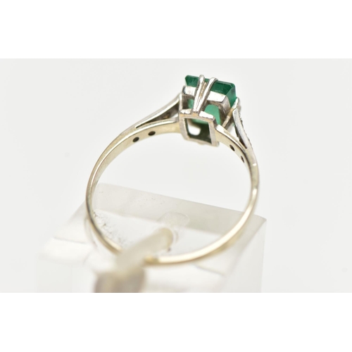 83 - A EMERALD RING, single emerald cut stones, split prong set in white metal flanked with six single cu... 