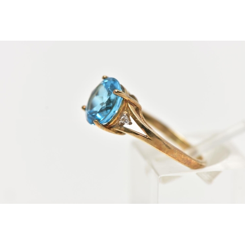 91 - A 9CT GOLD DRESS RING, a circular cut topaz, four prong set in yellow gold, flanked with two colourl... 