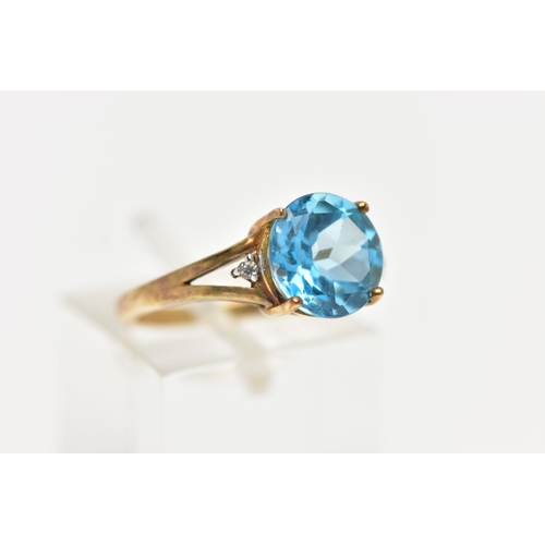 91 - A 9CT GOLD DRESS RING, a circular cut topaz, four prong set in yellow gold, flanked with two colourl... 