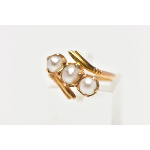 96 - A CULTURED PEARL RING, three cultured white pearls with a silver hue, prong set in a twisted mount d... 